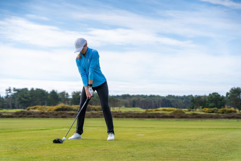 Female golfer hitting a driver off the tee